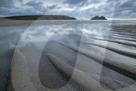 Tidal pools on the sandy beach at Holywell Bay, Cornwall, England. Summer (June) 2019.