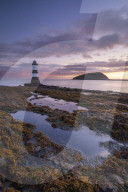 Sunrise over Penmon Point lighthouse, Anglesey, North Wales, UK. Autumn (September) 2017.