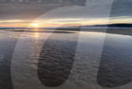 Sunset over the deserted sandy beach at Freshwater West, Pembrokeshire Coast National Park, Wales, UK. Spring (March) 2018.