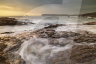 Waves surge over rock ledges on the North Cornish coast, Cornwall, England. Summer (July) 2019.
