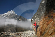Climber bouldering at Tangnag moraine, Khumbu