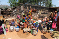 Bonda and Godaba tribeswomen selling home brewed alcohol at the entrance to weekly tribal market, Onukadelli, Odisha