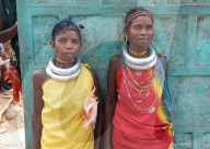 Godaba tribeswomen pausing with shopping on the long walk back to their village from weekly tribal market, Onukadelli, Odisha
