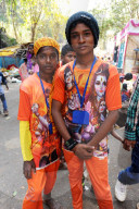 Two young pilgrims, in orange T shirts with images of Lord Shiva, going to Gupteswar cave Shiva shrine, Jeypore, Odisha