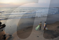 Fishermen preparing to cast fishing net at sunrise into the waters of the Bay of Bengal, Tranquebar, Tamil Nadu
