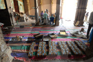 Donations of rupees being sorted, counted and bundled inside the 11th century Brihadisvara Cholan temple, Thanjavur, Tamil Nadu