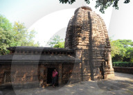 Priest standing at entrance to 7-8th century Parashurameshvara temple, one of the oldest in Bhubaneswar, Odisha
