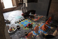 Priest arranging puja ceremony inside 7-8th century Parashurameshvara temple, Bhubaneswar, Odisha