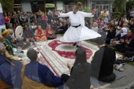 Zen buddhists and muslim sufis praying and celebrating together at the Salon Zen, Paris, France. Whirling dervish.