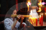 The Jade Emperor Pagoda. Vietnamese woman praying with incense sticks. Ho Chi Minh City. Vietnam.