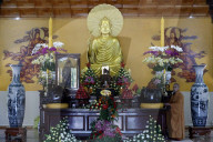 Truc Lam buddhist temple. Main altar with Buddha statue and monk. Dalat. Vietnam.