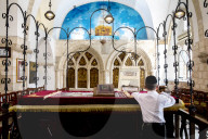 The 4 sephardic synagogues, Jerusalem old city, Israel. Boy reading at the teva.