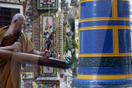 Ho Phap buddhist temple. Young monk ringing bell in monastery. Vung Tau. Vietnam.