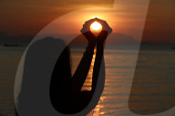 Silhouette of a woman standing by the sea at sunset. Kep. Cambodia.