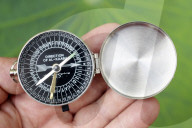 Muslim using a Qibla compass to indicate the direction of Al Kaaba. Close-Up on hand.