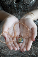 Buddhist woman with a Buddha pendant. Vung Tau. Vietnam.