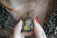 Buddhist woman with a Buddha pendant. Vung Tau. Vietnam.
