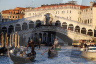 Rialto bridge and Grand Canal. Gondolier sailing on gondola. Venice. Italy.