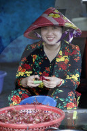Close-up of woman peeling garlic at local food market. Vung Tau. Vietnam.