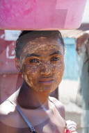 Girl with masonjoany a beauty mask obtained using the powder from the sandalwood of Madagascar shrub, Miandrivazo, Madagascar