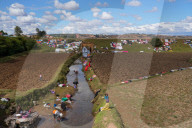 People doing laundry and drying it along the railway, Antsirabe, Central Madagascar