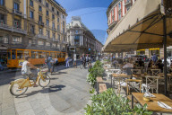 View of restaurant, tram and pedestrians on Via Dante, Milan, Lombardy, Italy, Europe
