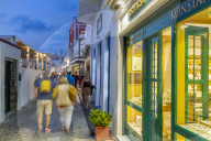 View of busy shopping street in Fita at dusk, Fira, Firostefani, Santorini (Thira), Cyclades Islands, Greek Islands, Greece, Europe