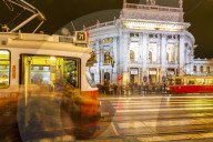 View of Burgtheater and city trams at night in Rathausplaza, Vienna, Austria, Europe
