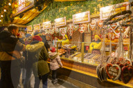 People at Christmas market stall at night in Rathausplaza, Vienna, Austria, Europe