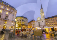 Christmas Market stalls and St. Michael Catholic Church in Michaelerplatz, Vienna, Austria, Europe