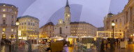 Christmas Market stalls and St. Michael Catholic Church in Michaelerplatz, Vienna, Austria, Europe