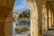 View of town and harbour through arches in Cavtat on the Adriatic Sea, Cavtat, Dubronick Riviera, Croatia, Europe