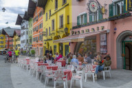 View of visitors enjoying drinks outside cafe on Vorderstadt, Kitzbuhel, Austrian Tyrol Region, Austria, Europe