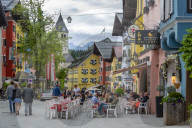 View of visitors enjoying drinks outside cafe on Vorderstadt, Kitzbuhel, Austrian Tyrol Region, Austria, Europe