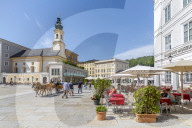 View of St. Michaelskirche and restaurants in Residenzplatz, Salzburg, Austria, Europe