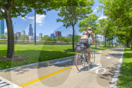 View of Chicago skyline and cyclist on South Lake Shore Drive, Chicago, Illinois, United States of America, North America