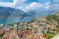 View of cruise ship and red rooftops of the Old Town, UNESCO World Heritage Site, Kotor, Montenegro, Europe