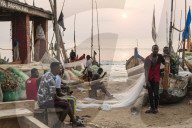 Fishermen fixing nets, Cape Coast, Ghana, Africa