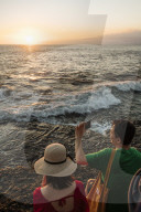 Tourists enjoying sunset at Tanah Lot Temple, Bali, Indonesia