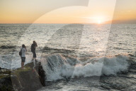 Tourists enjoying sunset at Tanah Lot Temple, Bali, Indonesia