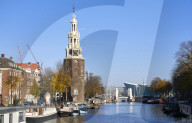 Montelbaanstoren Tower and Oudeschans canal in Amsterdam, Netherlands.
