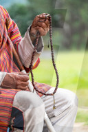 Close up of man holding Buddhist prayer beads, Bhutan.