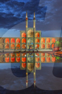 Amir Chaqmaq complex facade illuminated at sunrise and reflecting in a pond, Yzad, Yazd province, Iran
