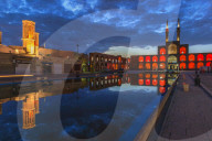 Amir Chaqmaq complex facade illuminated at sunrise and reflecting in a pond, Yzad, Yazd province, Iran