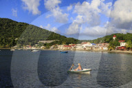 Deshaies waterfront, couple in rowing boat, Death In Paradise Saint Marie location, Basse Terre, Guadeloupe, Caribbean