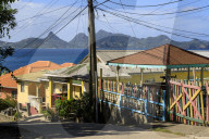 Quiet Caribbean, colourful buildings, main street, Mayreau, distant Union Island, Grenadines, St Vincent, West Indies