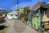 Quiet Caribbean, colourful buildings, sleeping dog, main street, village, Mayreau, Grenadines, St Vincent, West Indies