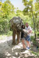 A young couple with a rescued elephant at Phnom Tamao Wildlife Rescue Center (PTWRC) run by Wildlife Alliance, near Phnom Penh