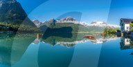Panoramic of mountains reflected in the clear water of Oppstrynsvatn lake, Hjelle, Oppstryn, Sogn og Fjordane county, Norway