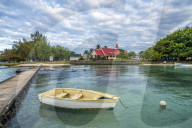 Boat moored in the sea surrounding the Notre Dame Auxiliatrice Church, Cap Malheureux, Indian Ocean, Mauritius